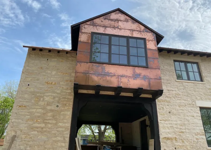 Copper metal panel facade on a stone building for Metal Roof Coating in Pocatello